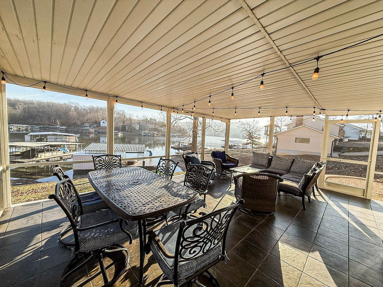 Dine, relax, and entertain on the spacious covered lakefront deck with string lights and panoramic water views.
Perfect for family gatherings, lake vacations, and sunset dinners, this waterfront Airbnb offers outdoor living at its best.