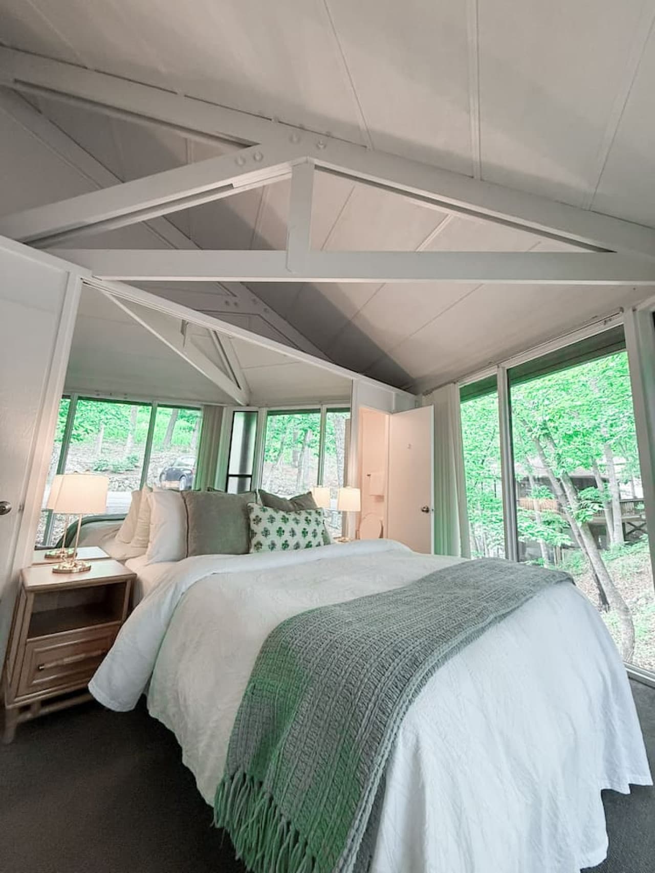 Comfortable bedroom showcasing the unique interior design and a spiral staircase adding character to this Treetop Village unit.