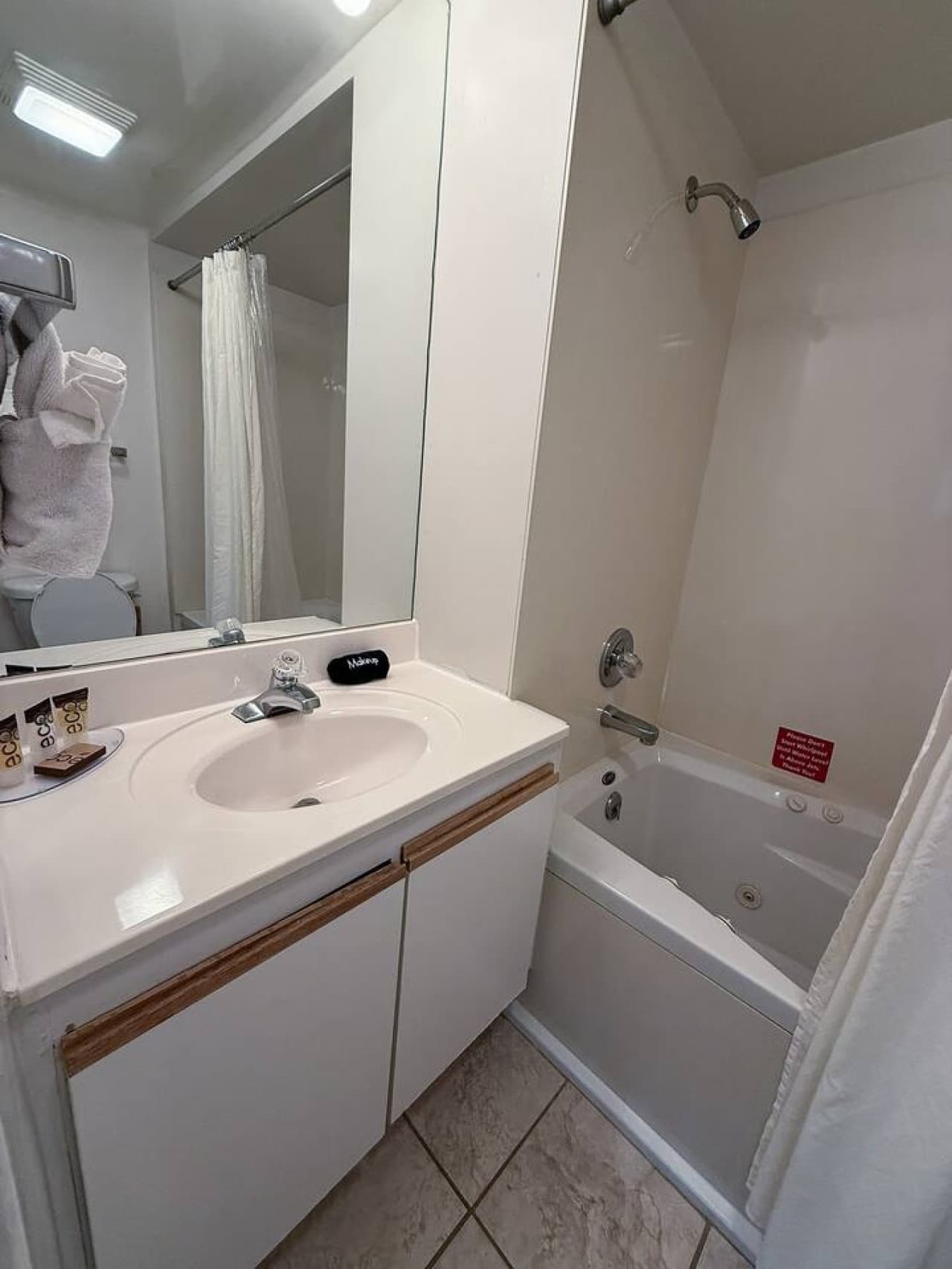 One of the unit's three full bathrooms, featuring a convenient vanity and a tub/shower combination for your comfort and ease.