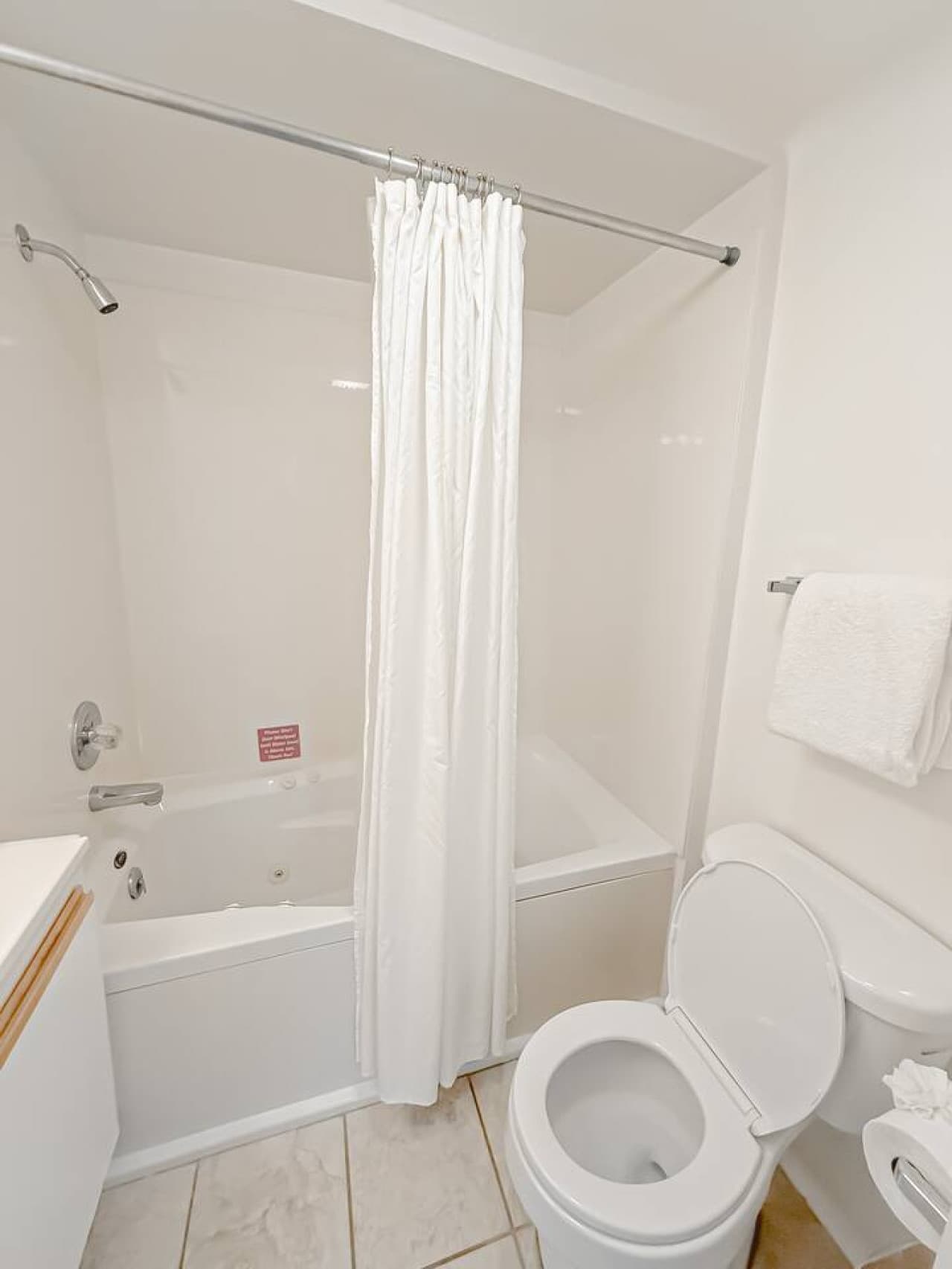 One of the three full bathrooms, complete with a shower/tub combination, ensuring convenience and comfort for all guests.