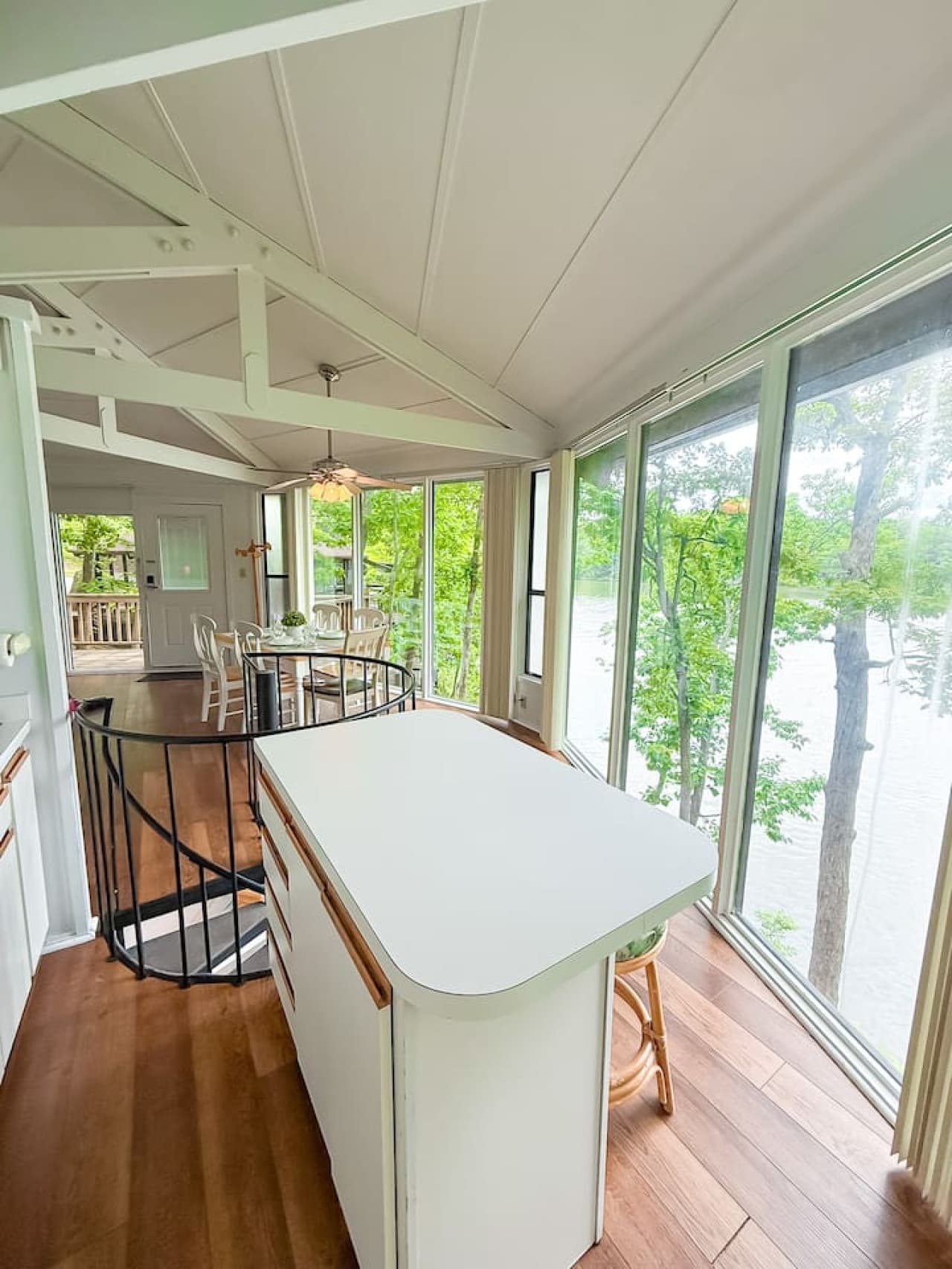 The bright and open kitchen with a convenient island, seamlessly connected to the dining area and offering picturesque views of the lake.