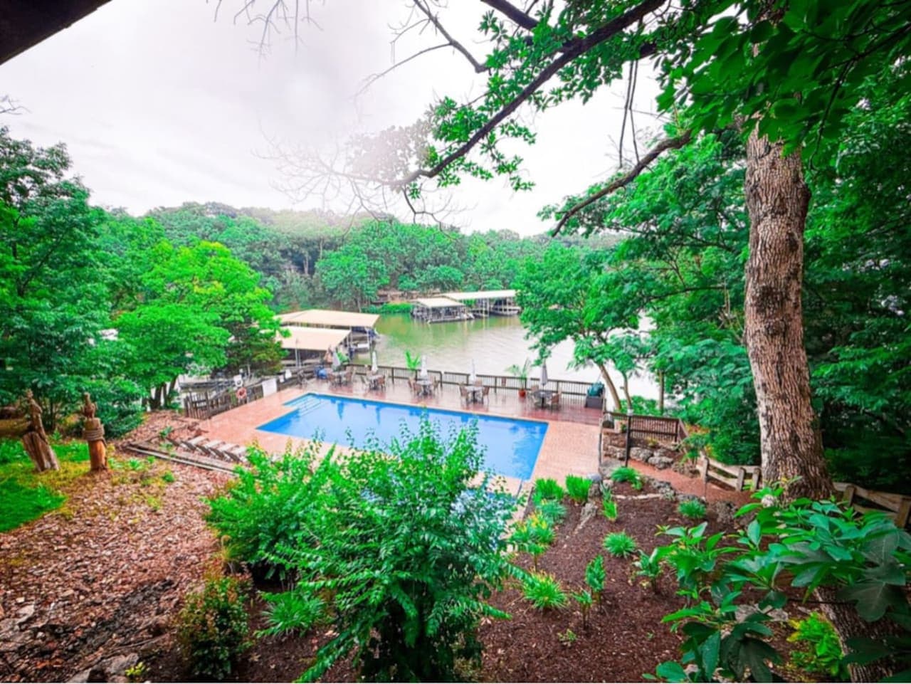 Nestled among the trees with stunning lake views, this serene pool is one of two exclusive lakefront pools available to Treetop Villa guests.