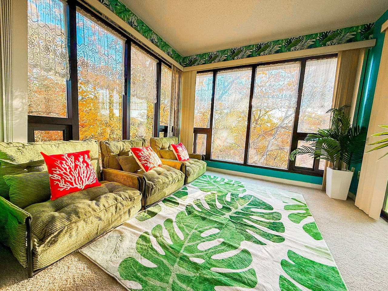 Sun-drenched bonus room with lush greenery and a cozy, tropical vibe.