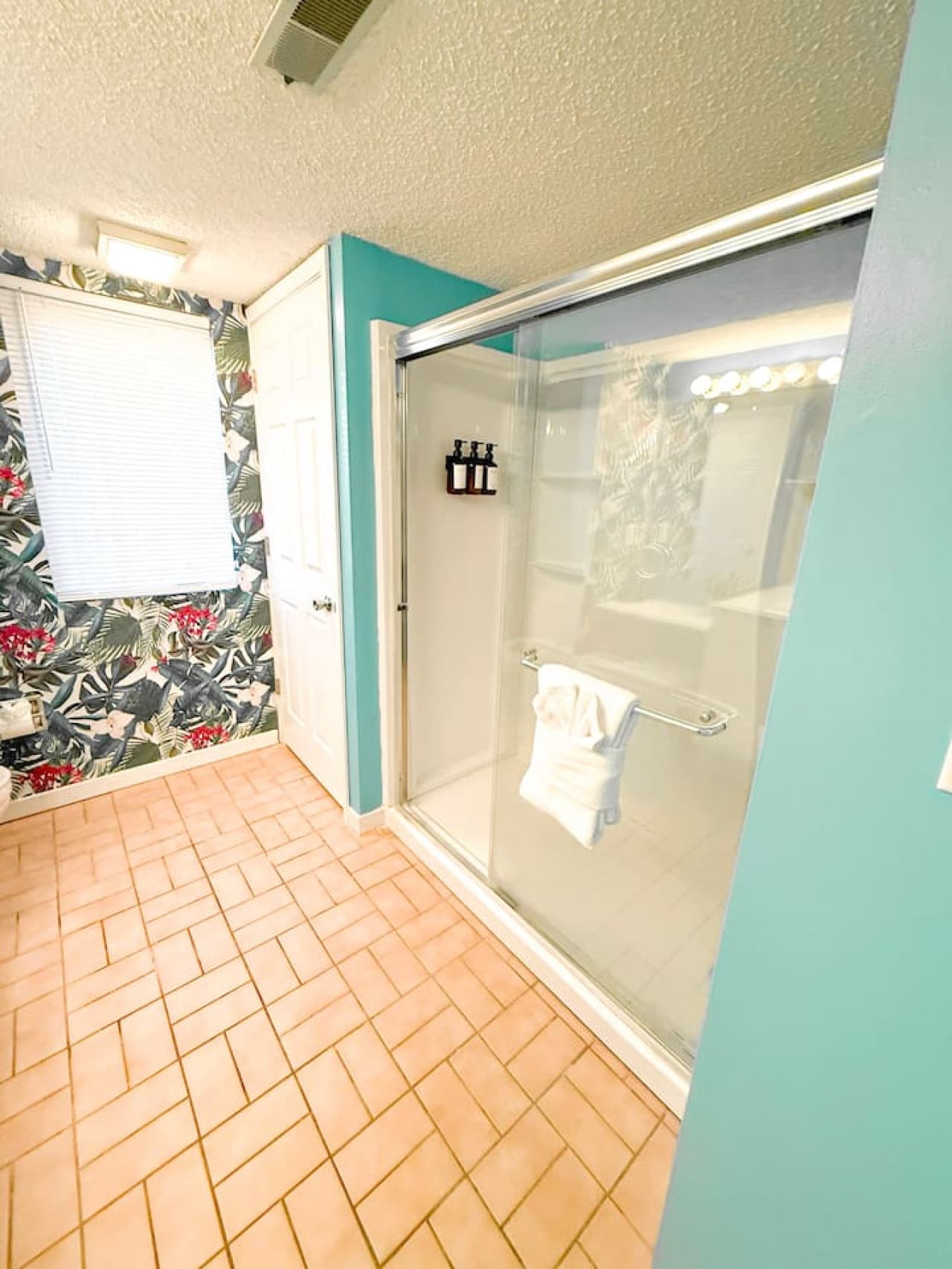 Spacious shower in a vibrant bathroom.