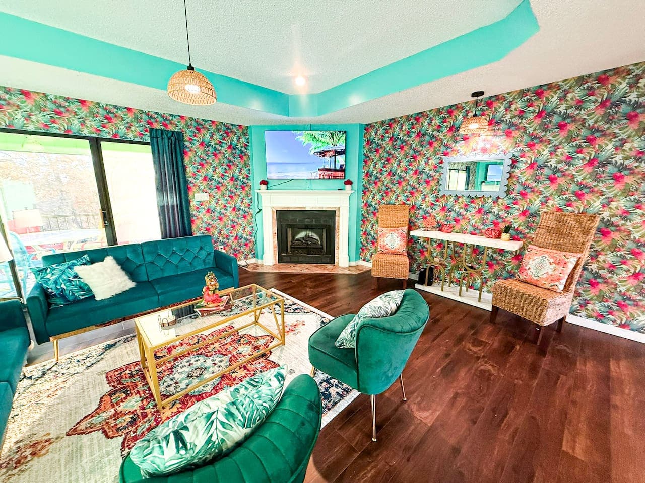 Bold, tropical-themed living room with fireplace and TV.