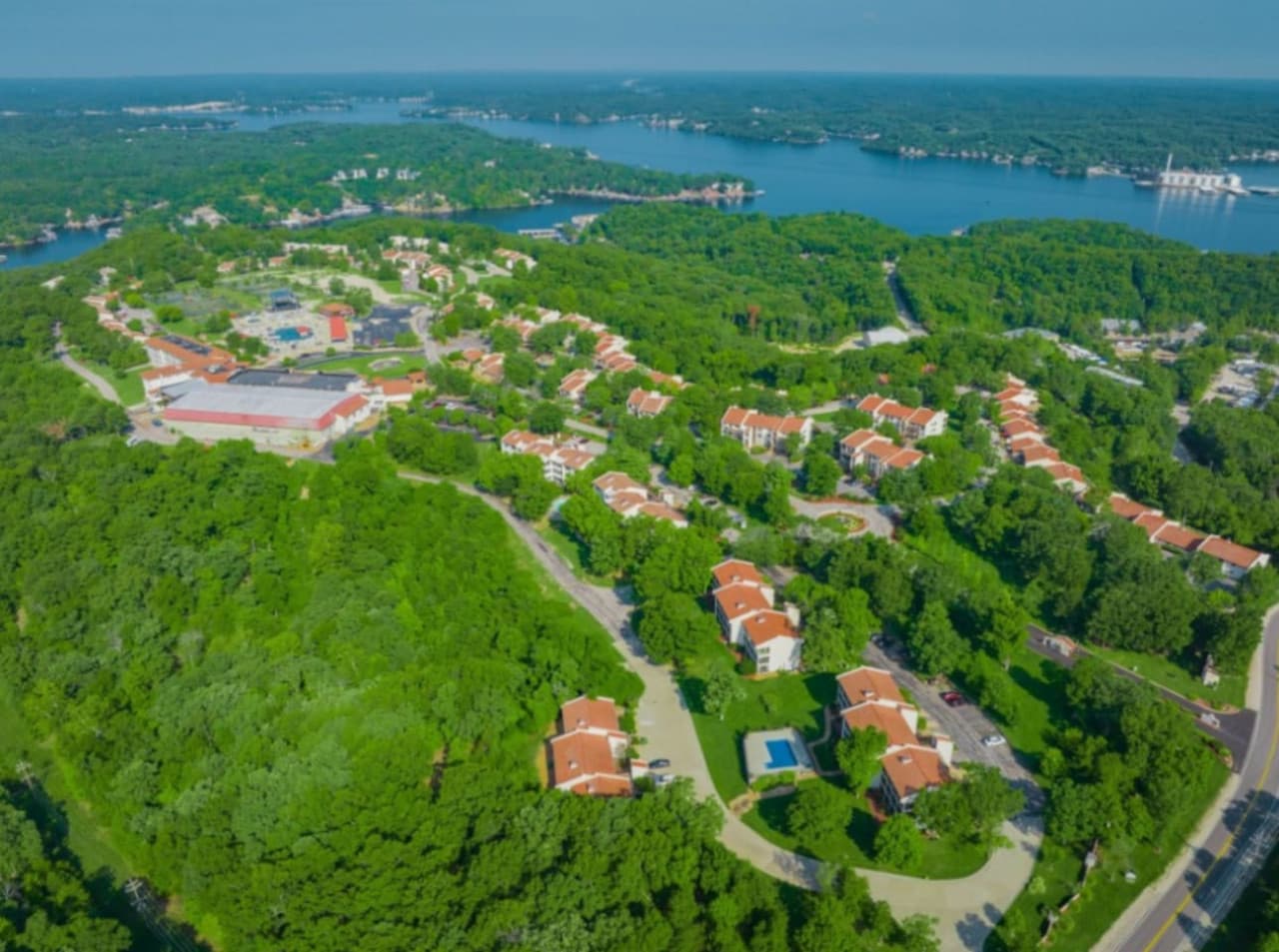Expansive aerial of the neighborhood with lake in the distance.