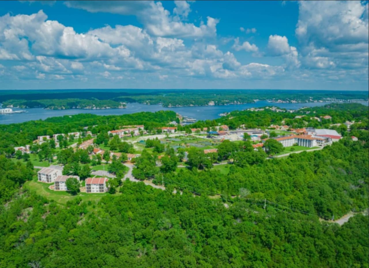 Aerial view of the lush resort community by the lake.
