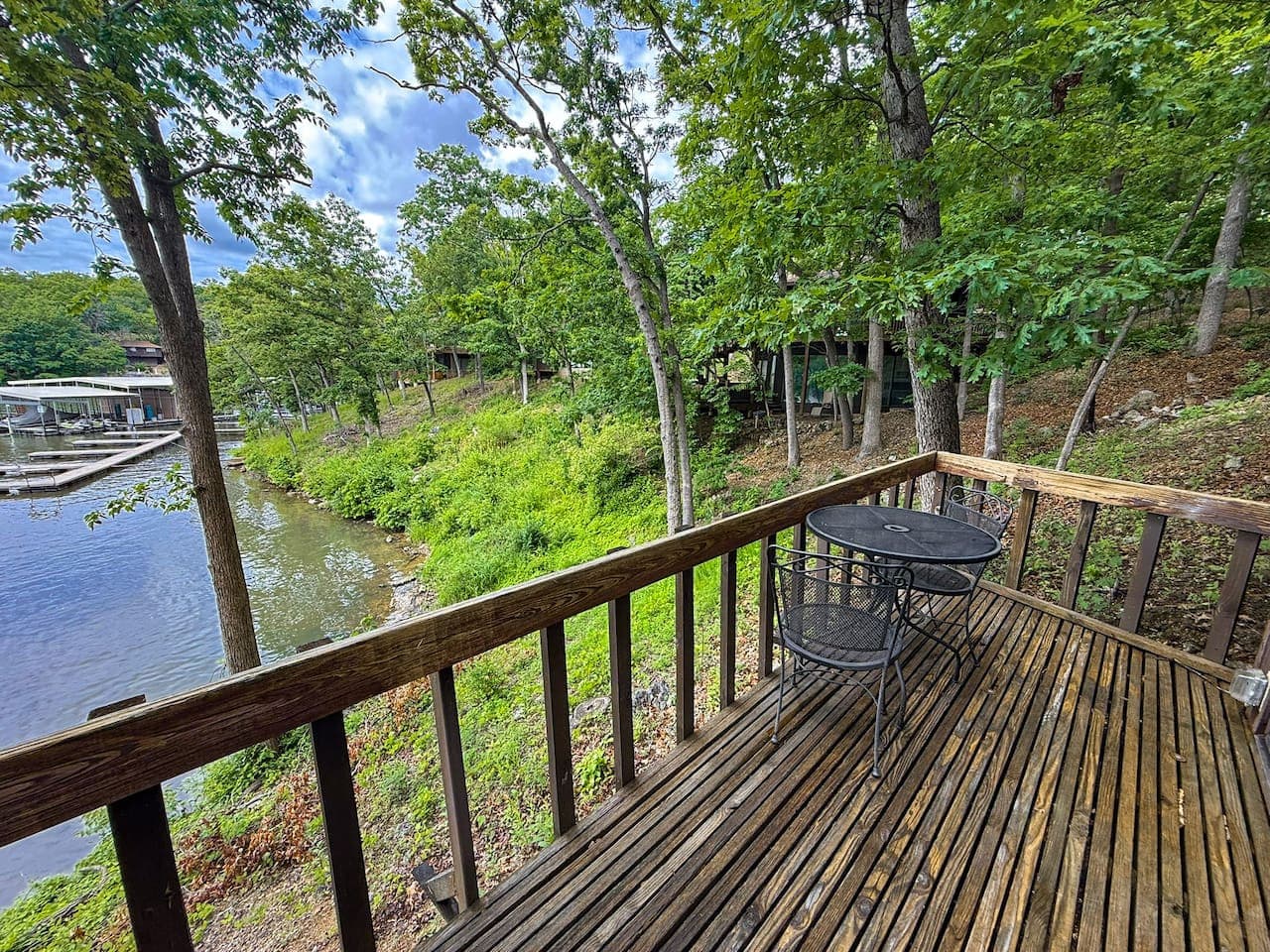 Another inviting perspective from the deck, showcasing the proximity to the lake and the nearby boat dock, perfect for waterfront activities.