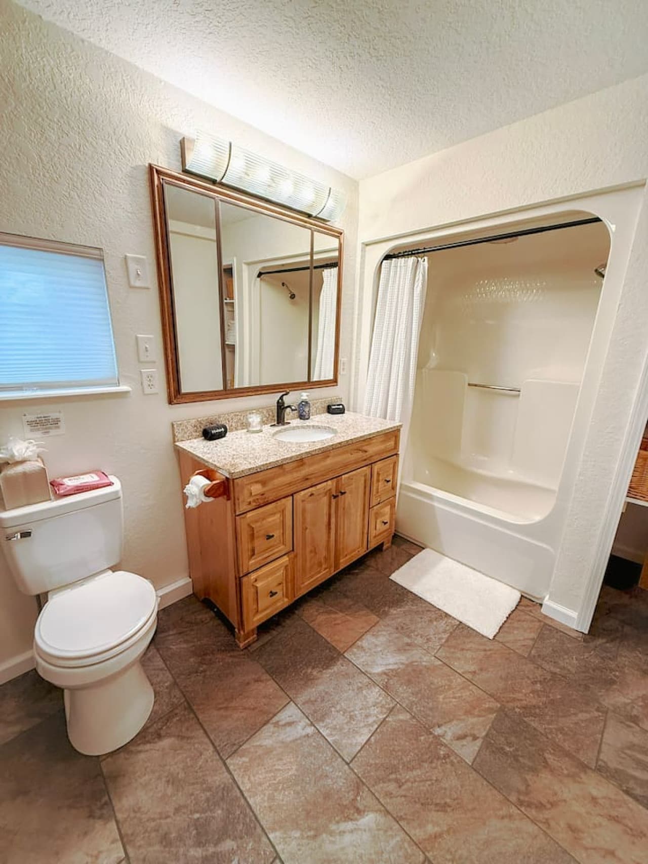 Includes shower-tub combo and ample space.