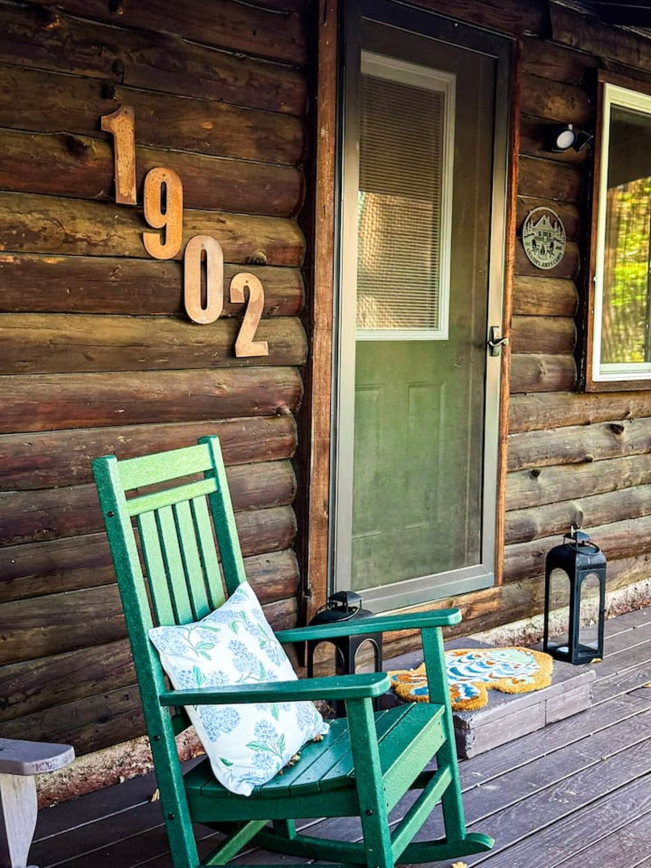 Charming porch with a cozy green rocker.
