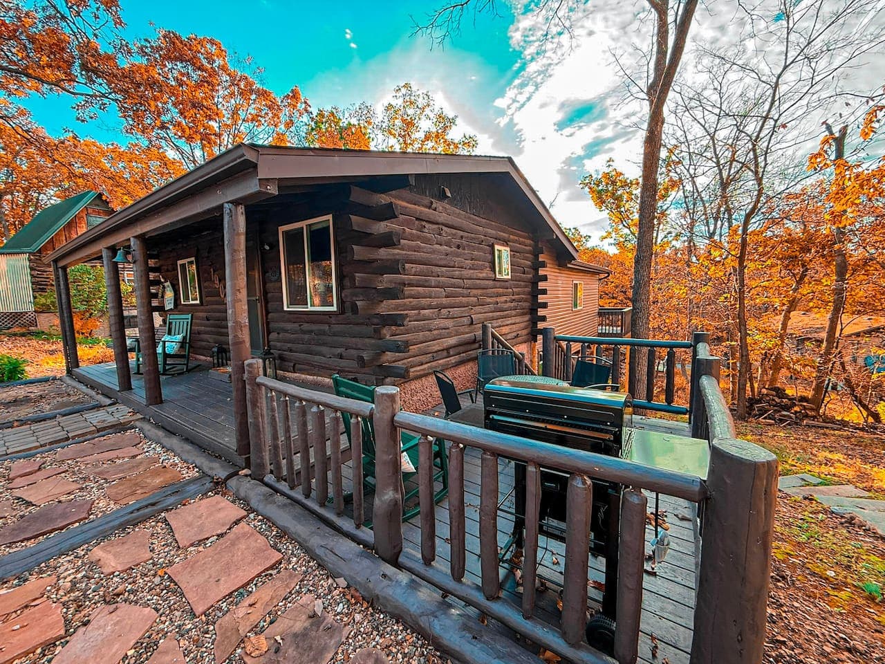Classic log cabin with outdoor dining space.