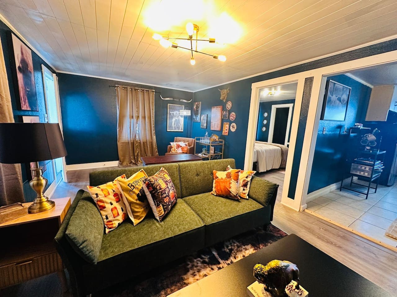 The cozy living space blends lodge-style warmth with rich bourbon hues.