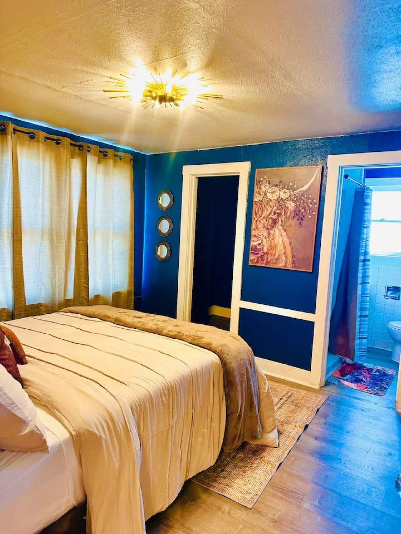 Drift off to dreamland in our cozy bedroom. The rich blues and warm accents create a relaxing retreat.