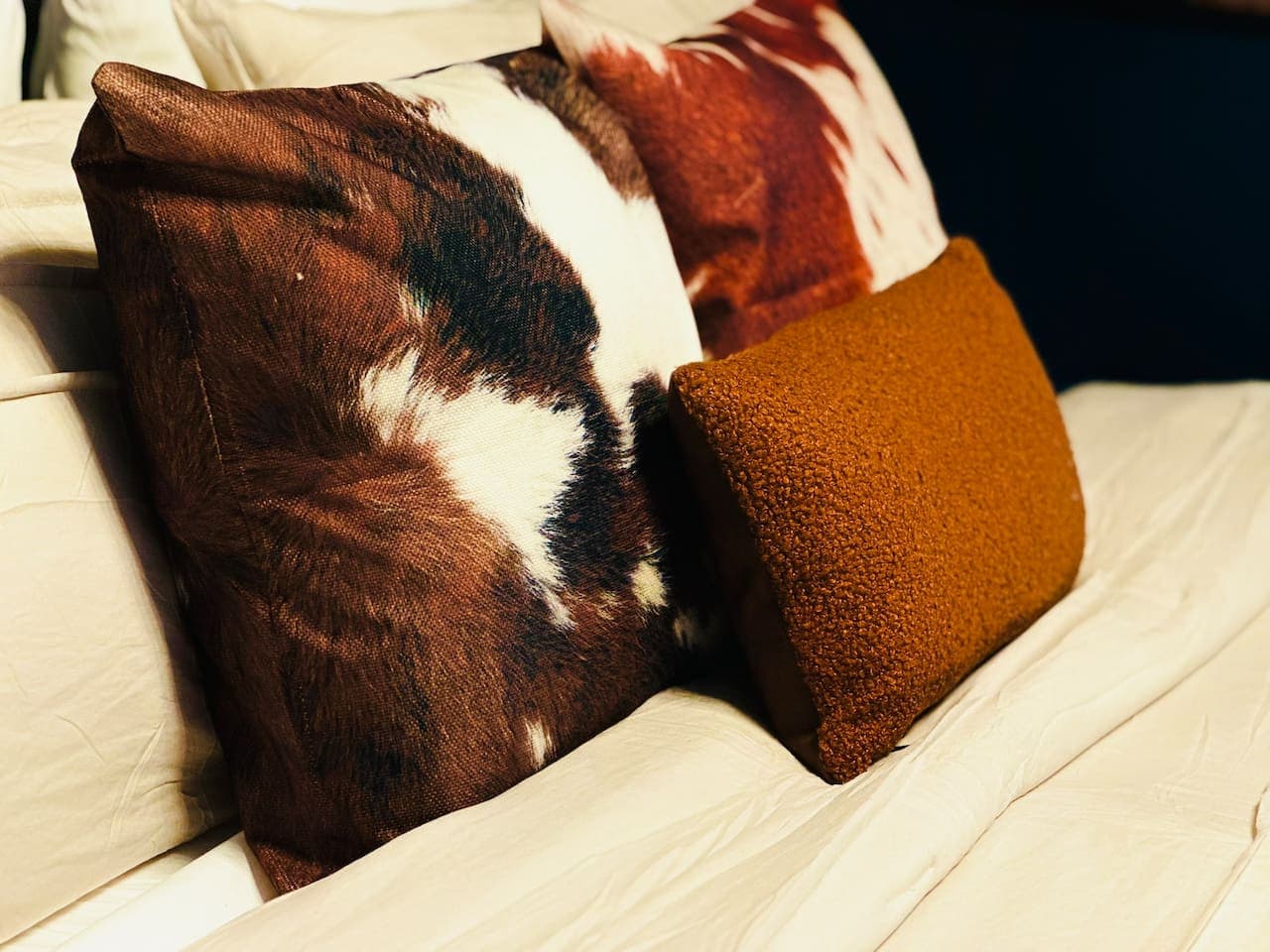 Sink into softness! Our cozy pillows are perfect for a restful night's sleep in the Buffalo & Bourbon Bungalow.