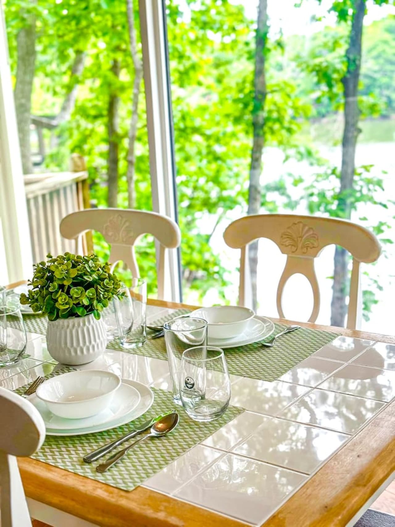 Dine with a view! Enjoy your meals surrounded by lush greenery and a serene lake backdrop at our dining area.