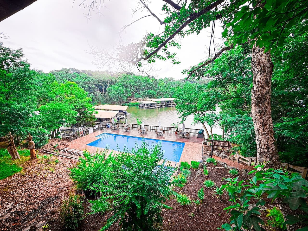 Nestled among the trees with stunning lake views, this serene pool is one of two exclusive lakefront pools available to Treetop Villa guests.
