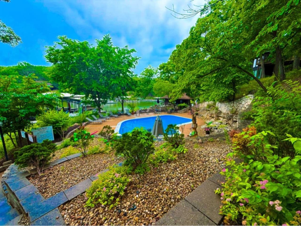 Descend to the inviting communal pool area at Lakefront Treetop Village, offering a refreshing oasis with stunning views of the lake and surrounding greenery.
