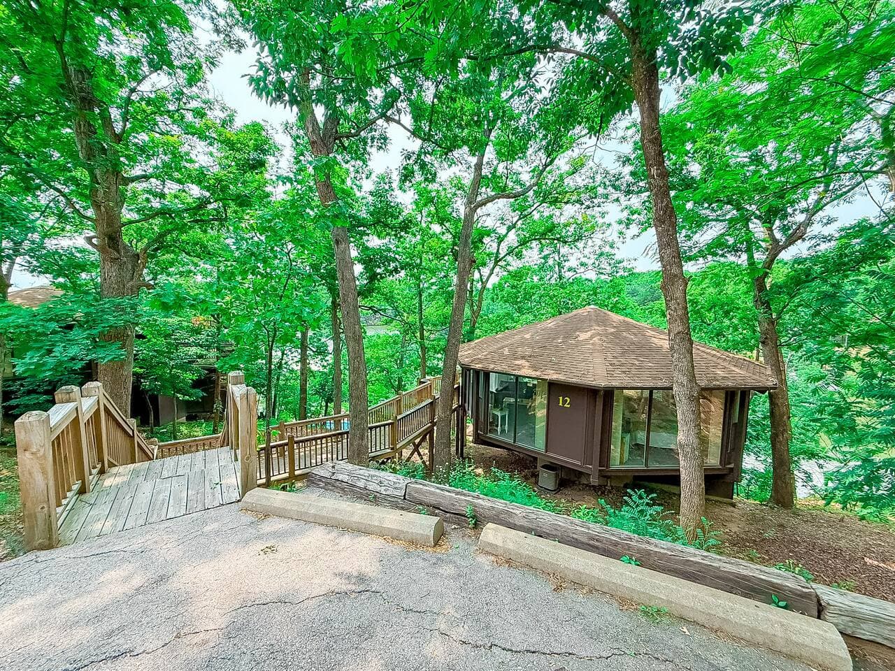 This modern elevated home offers a unique "treetop" living experience, blending seamlessly with the surrounding lush natural landscape. Multiple large windows allow for abundant natural light and scenic views, making this a bright and inviting retrea