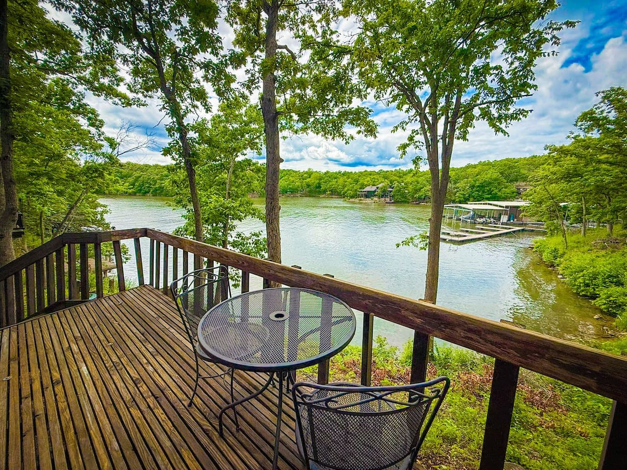 Savor your morning coffee or evening cocktails on the private deck of Unit 12, offering stunning views of the tranquil lake and surrounding nature.