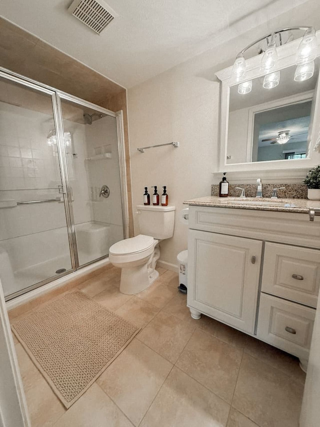 This pristine bathroom boasts a spacious walk-in shower with a glass enclosure and a generously sized vanity, offering both style and functionality. The neutral color palette and clean lines create a serene and refreshing retreat.
