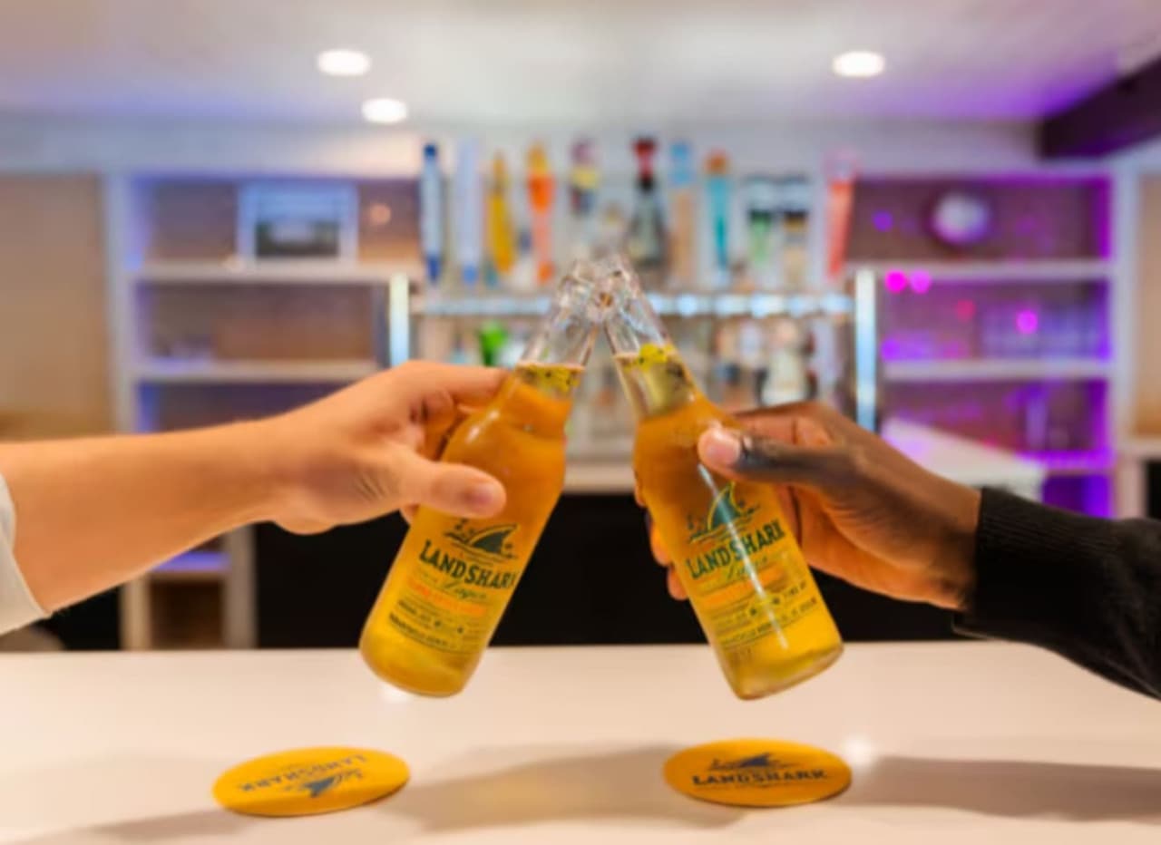 This vibrant entertainment space features a modern bar area, complete with stylish shelving and ambient lighting, perfect for social gatherings. The inviting atmosphere is ideal for hosting lively events and creating memorable experiences.