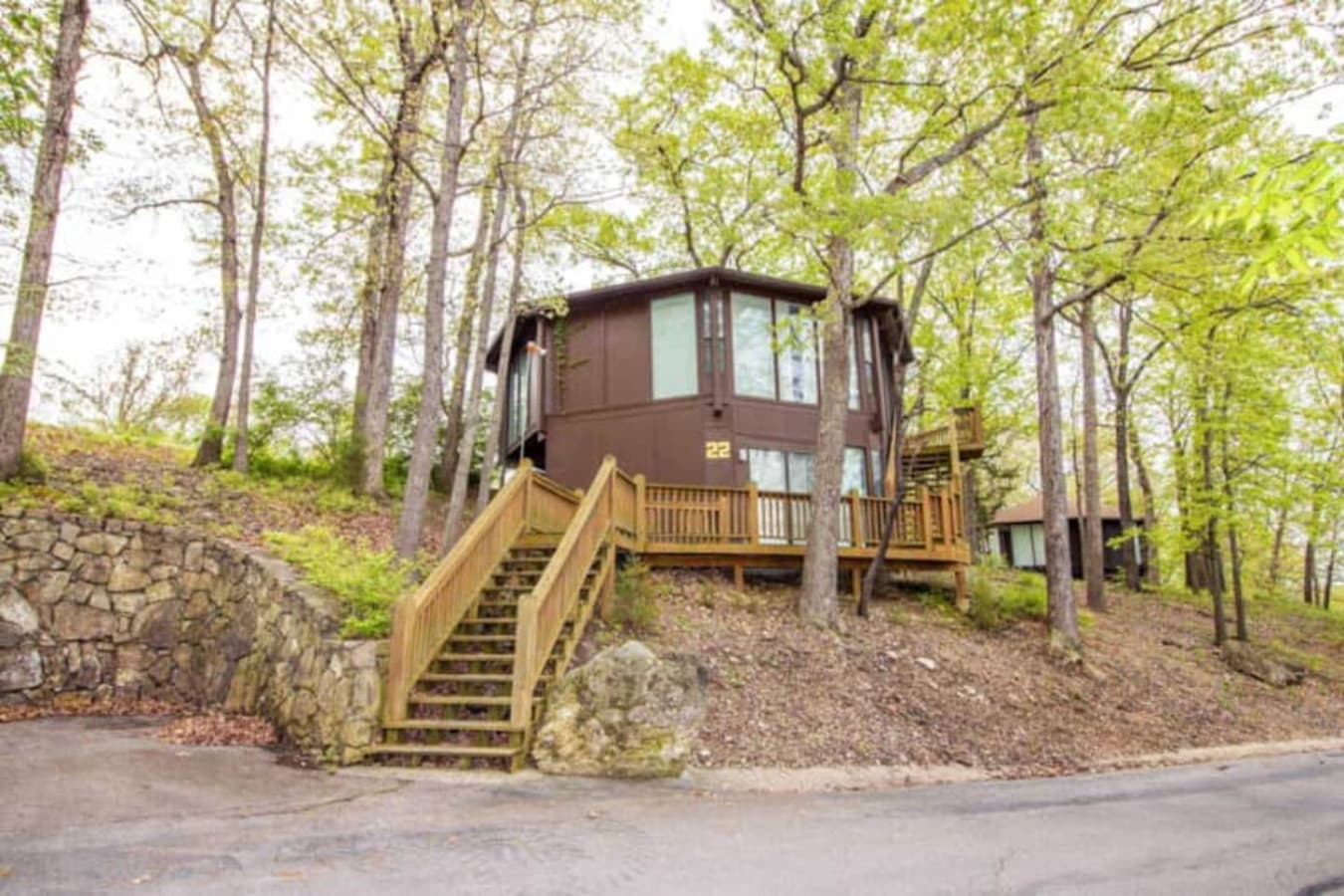 This modern elevated home offers a unique "treetop" living experience, blending seamlessly with the surrounding lush natural landscape. Multiple large windows allow for abundant natural light and scenic views, making this a bright and inviting retrea