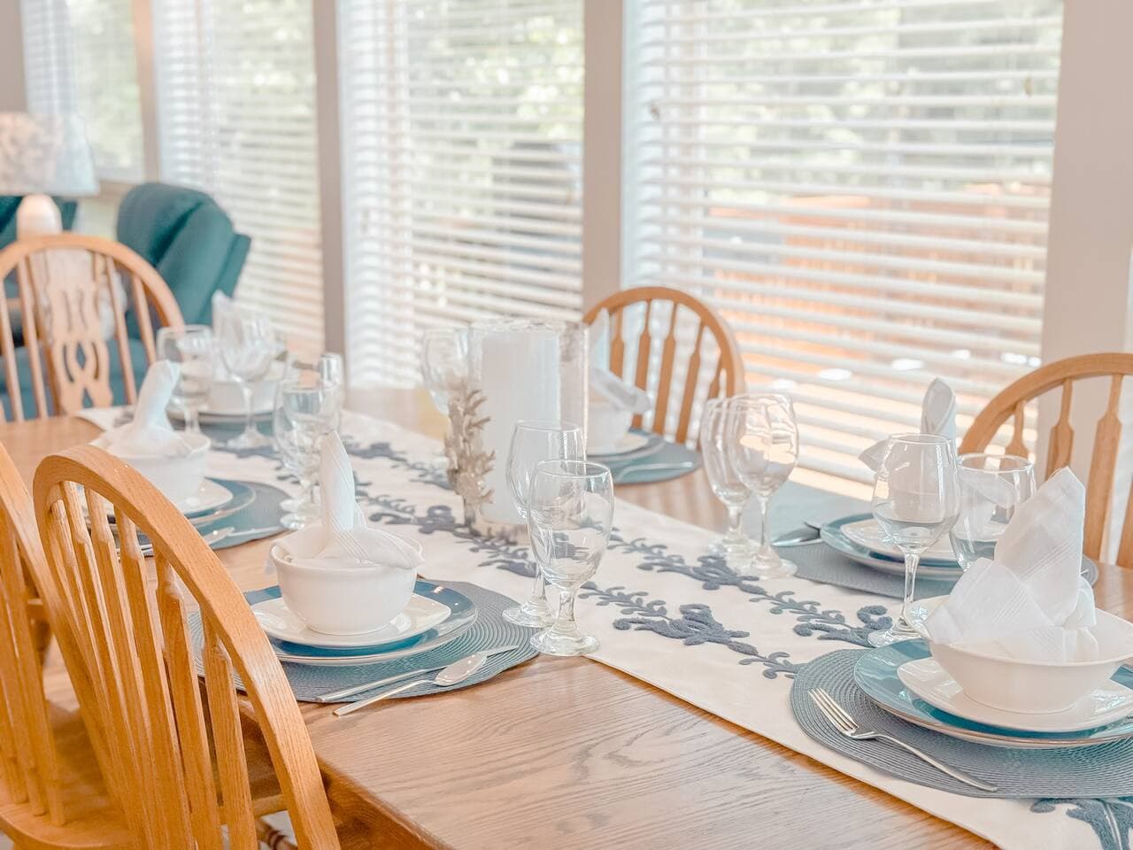 A stylish six-seater dining area perfectly positioned next to expansive floor-to-ceiling windows, offering a bright and inviting space for meals with stunning views.