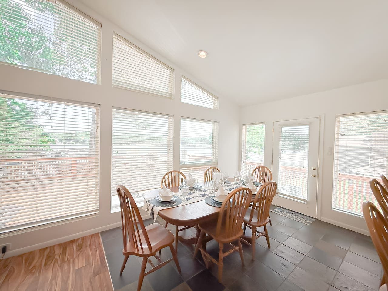 A bright, open dining space for 6, with large windows that flood the room with natural light, offering the warmth and charm of a sunroom.