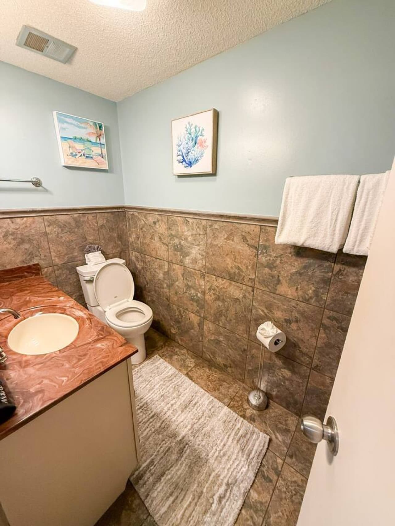A bathroom with a walk-in shower, complemented by a washer and dryer, combining elegance with practicality.