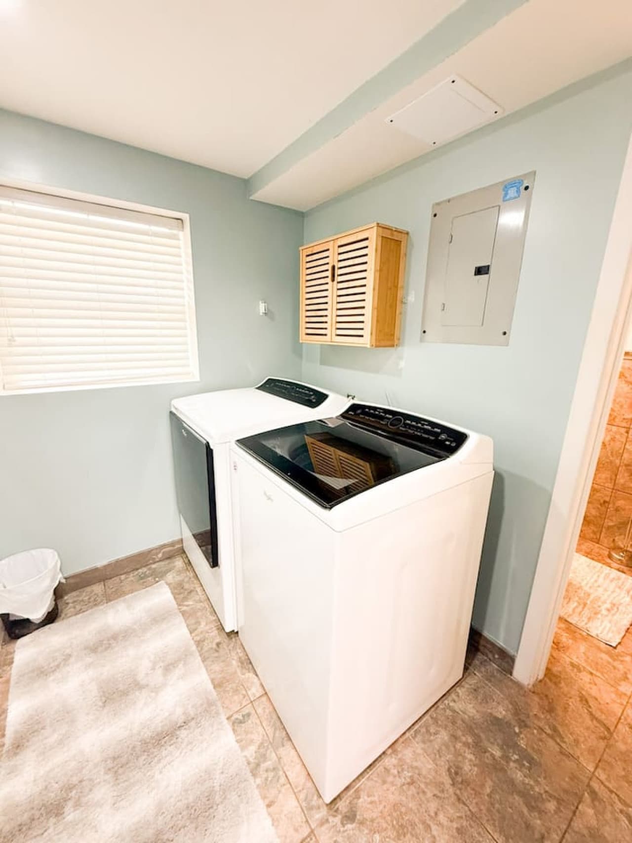 Convenient laundry room featuring a washer and dryer, storage, and a clean, functional design for effortless laundry days.