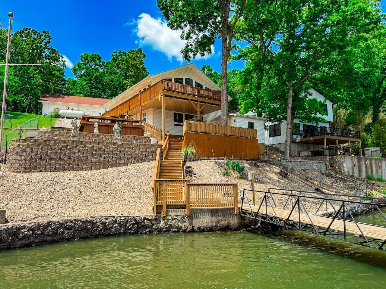 Imagine waking up in this beautiful lakeside home.  Take in the peaceful view—the sound of gentle waves and birds in the trees creating a perfect start to your day.
