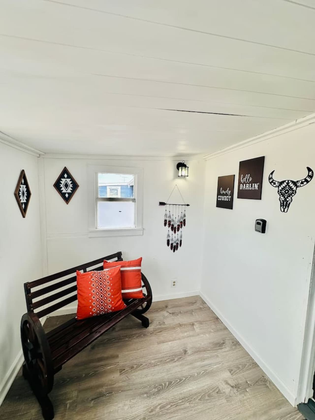 The entryway offers a cozy, western-inspired bench—perfect for kicking off your boots.