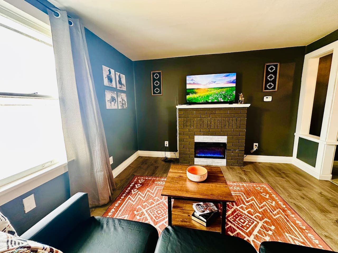 Comfortable living area featuring an electric fireplace and curated western decor.