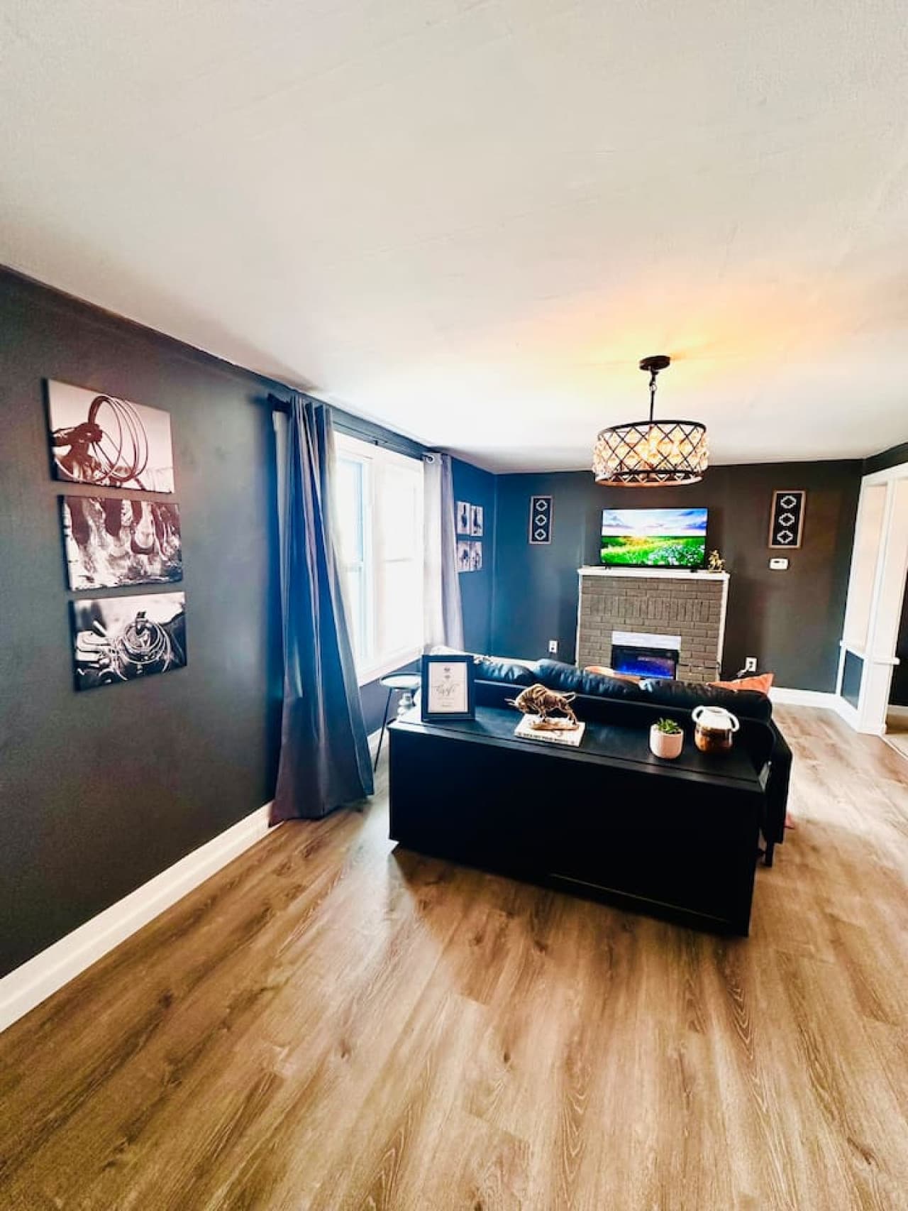 Spacious living room with a modern fireplace and mounted TV for relaxing nights in.