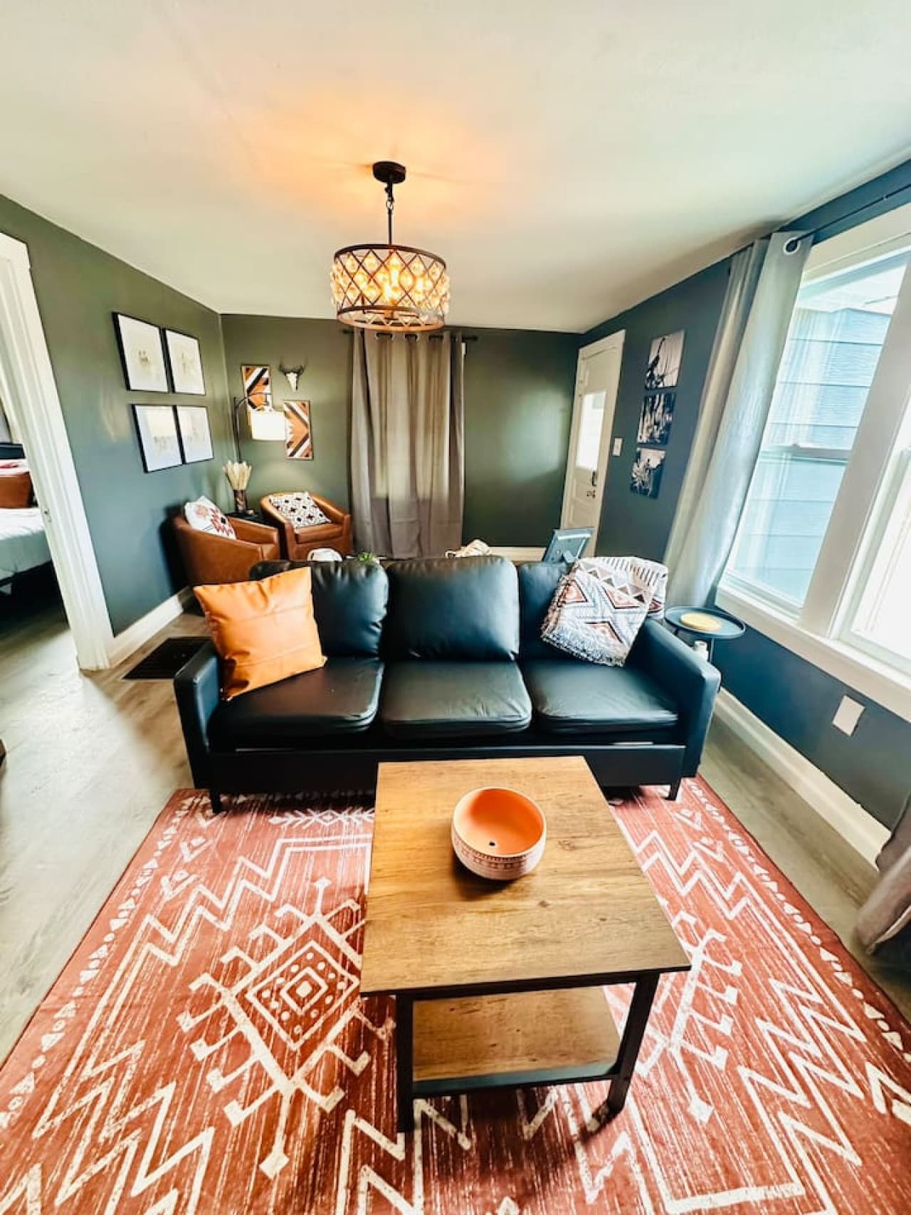Natural light fills the living space, designed with warm tones and modern comfort.