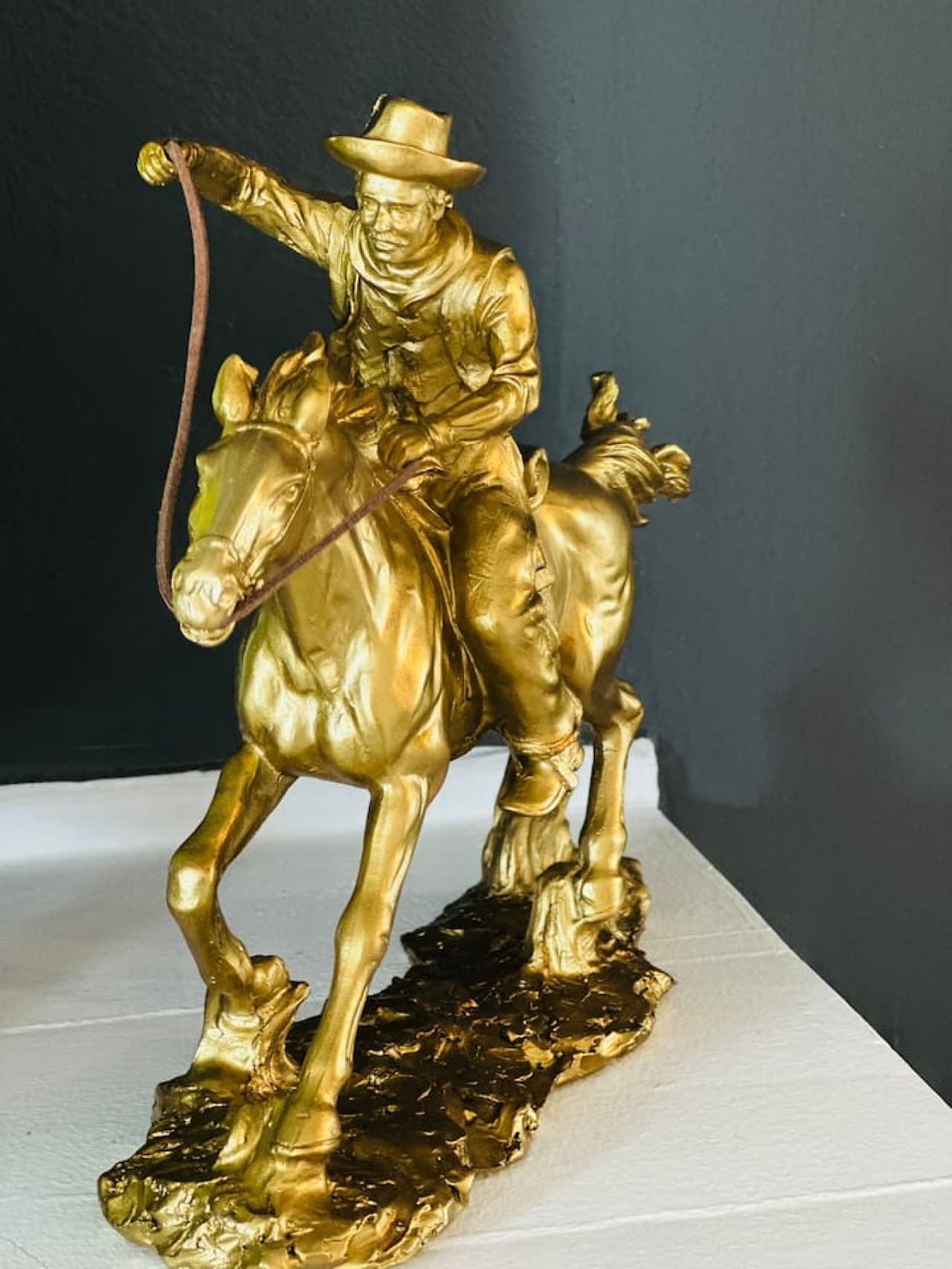 Vintage-style cowboy sculpture adds a touch of character to the mantle.