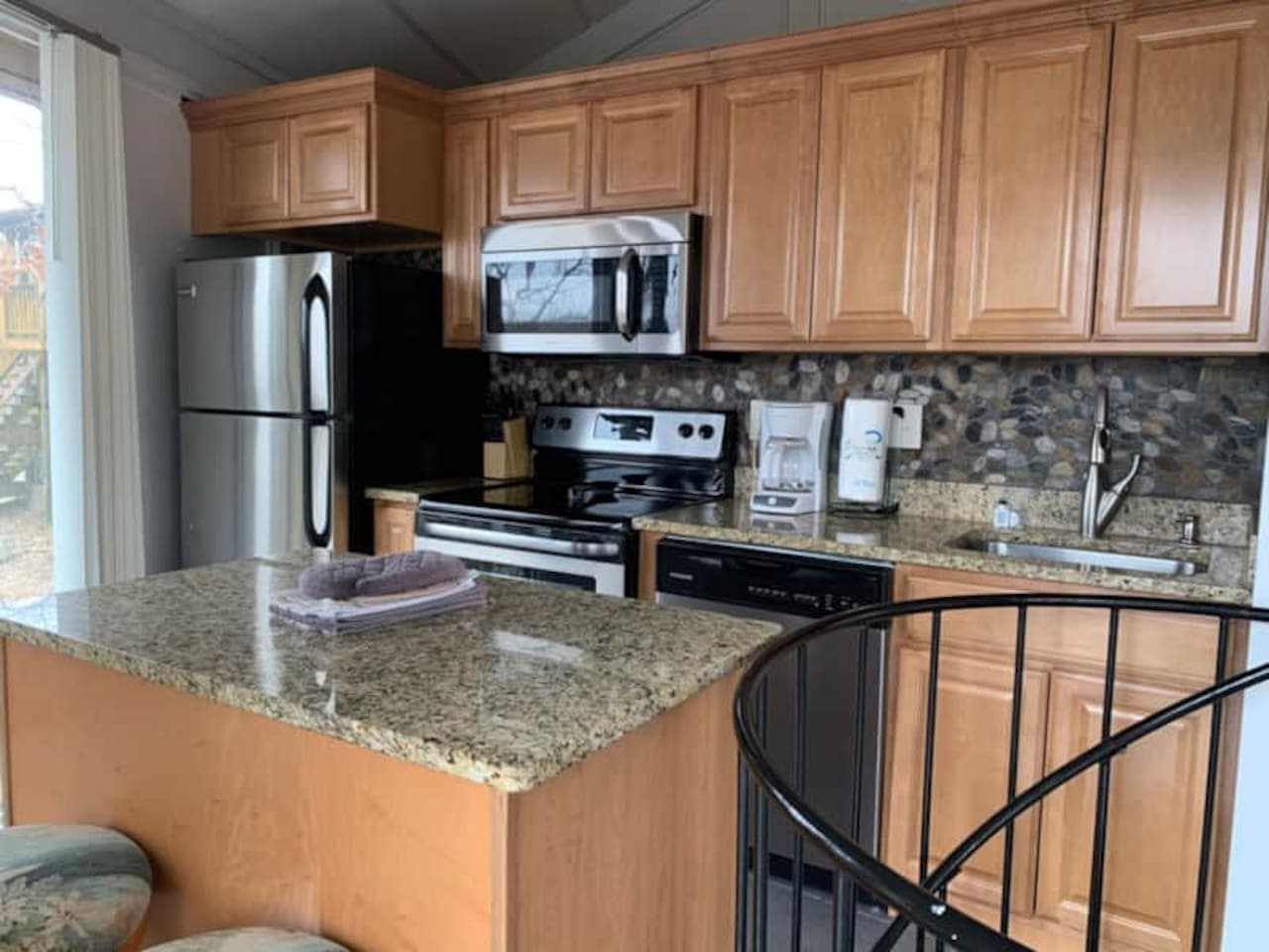 Prepare meals with ease in the well-equipped kitchen, featuring all the essentials for your stay at Treetop Village.