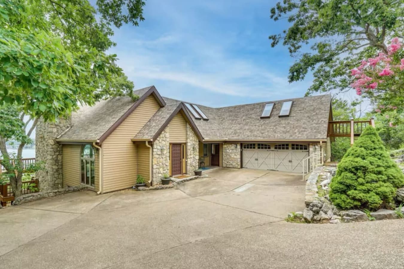 Stunning lakefront home with charming architectural details and ample  private parking with easy access to the main floor, set in a prime Osage Beach location.