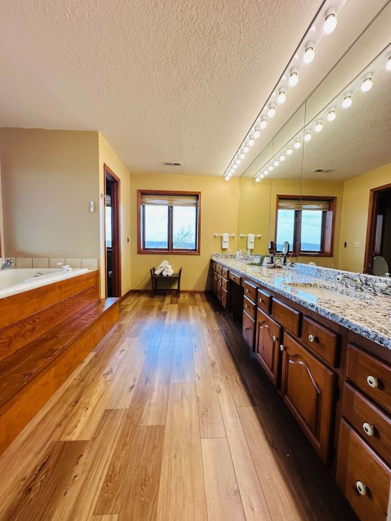 Convenience meets luxury with a double vanity, ample counter space, and panoramic windows in the master bathroom.