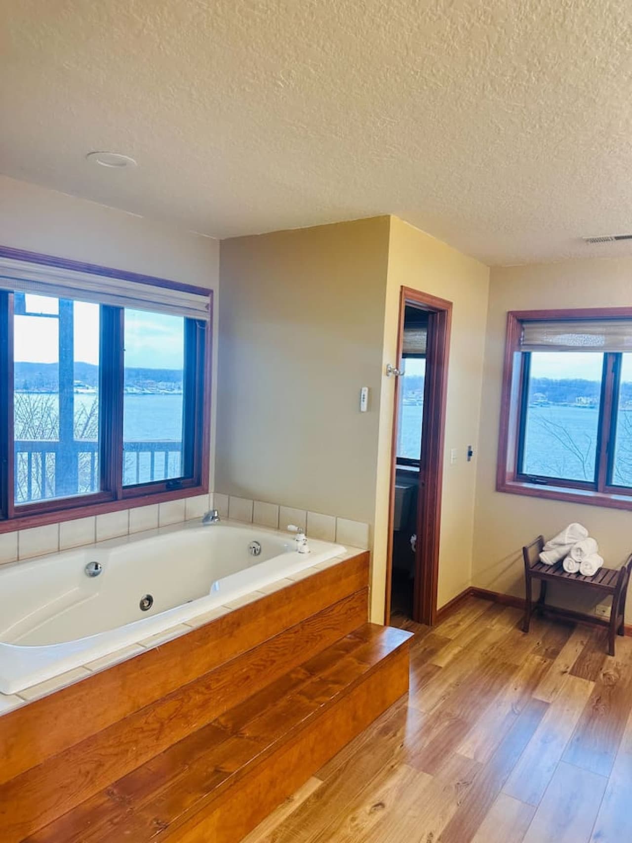 Indulge in the spacious master bathroom, complete with a large soaking tub and breathtaking lake views.