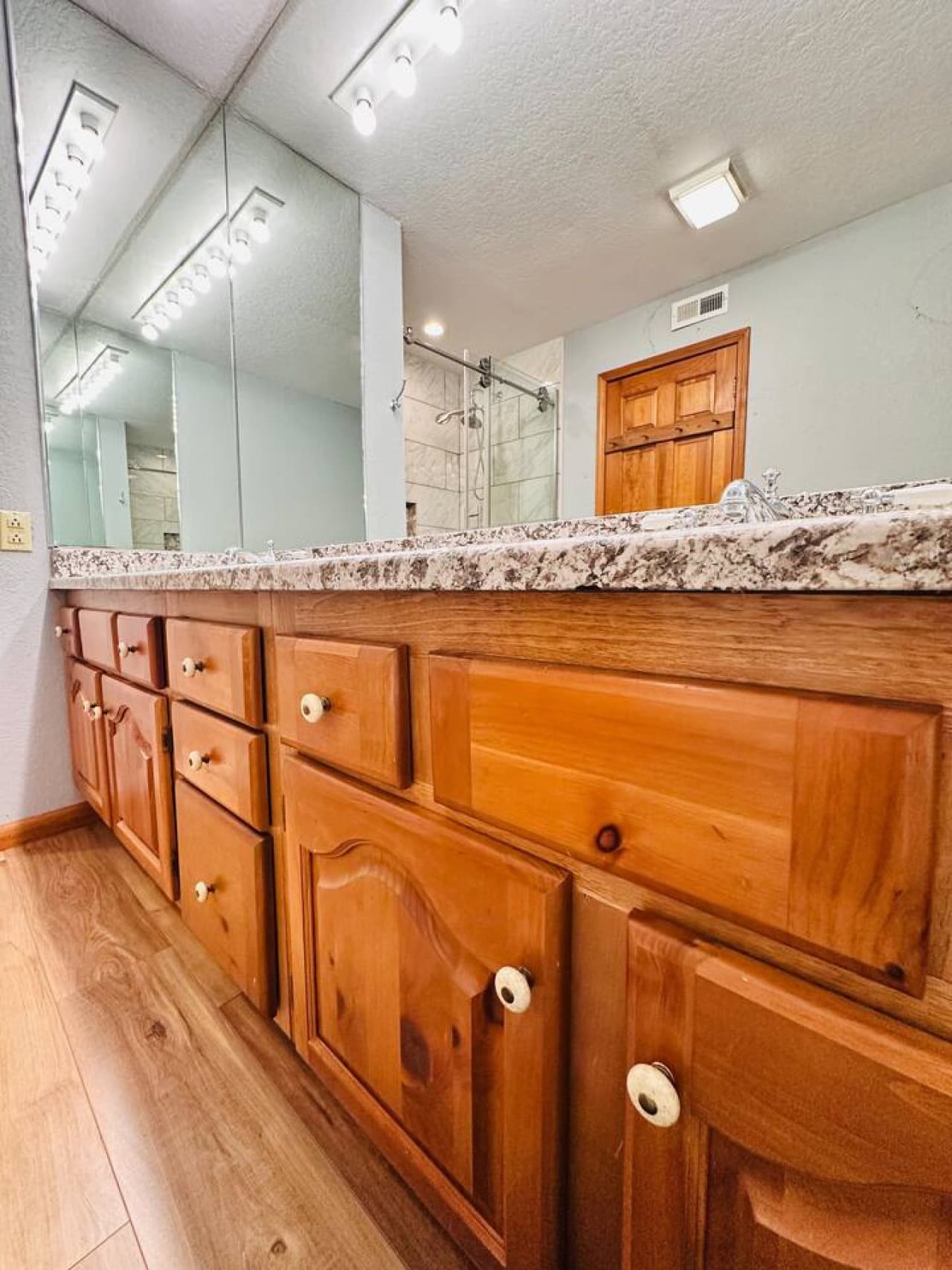 This bathroom offers a double granite vanity with plenty of storage and counter space for your essentials.