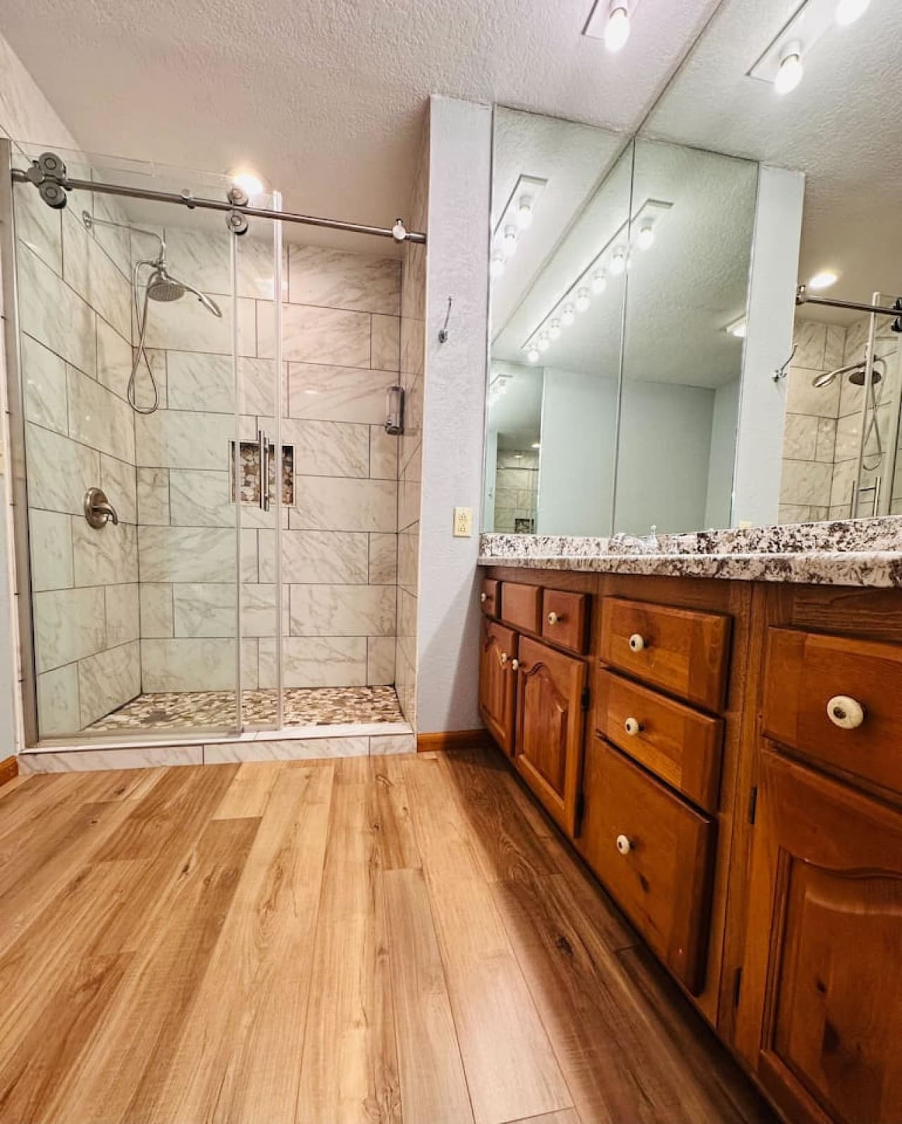 This detached bathroom on the middle level features a large granite countertop and plenty of space for your convenience.