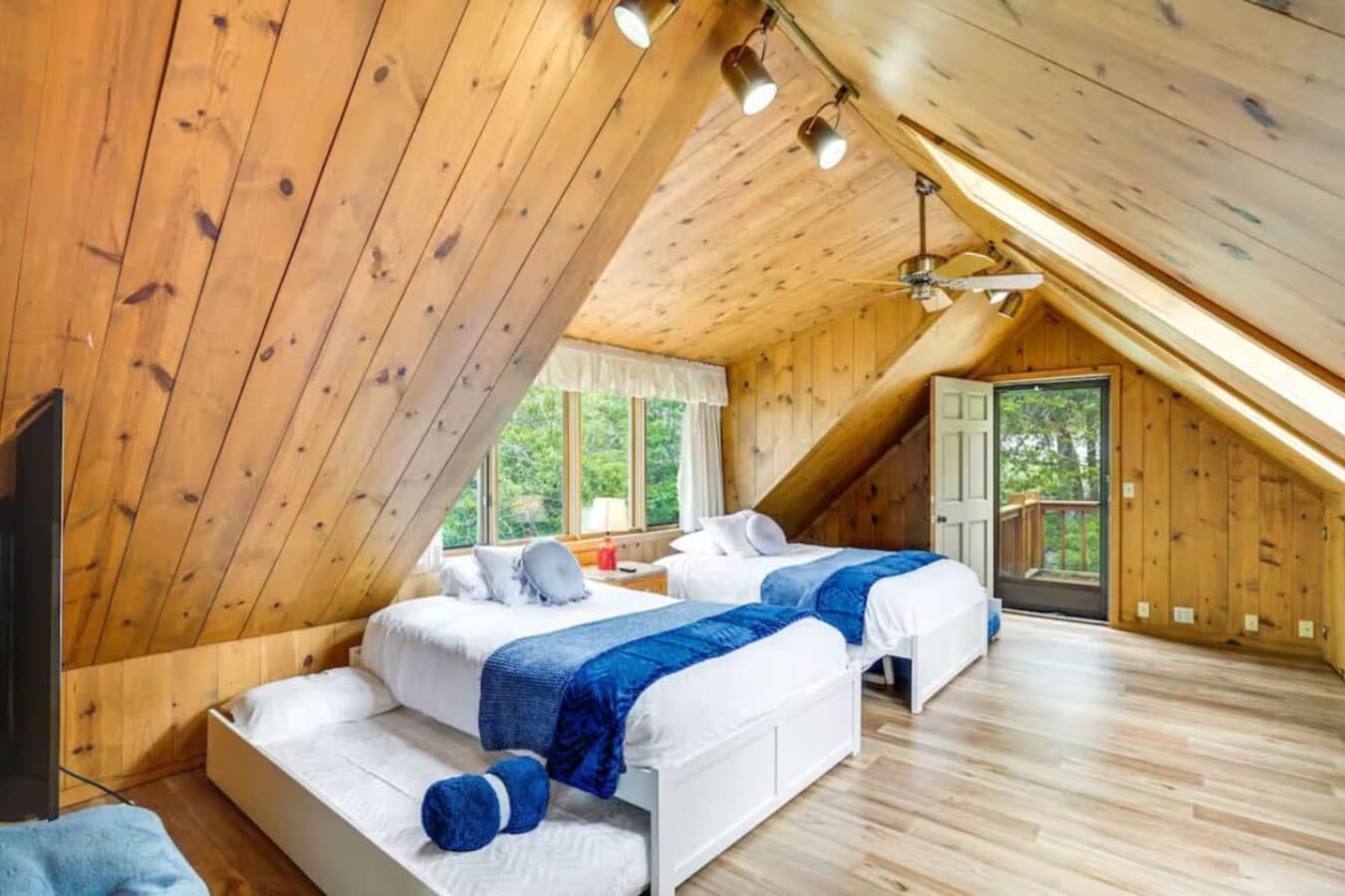 The cozy bunk room features 5 full beds and a twin, perfect for kids or groups, with scenic lake views.