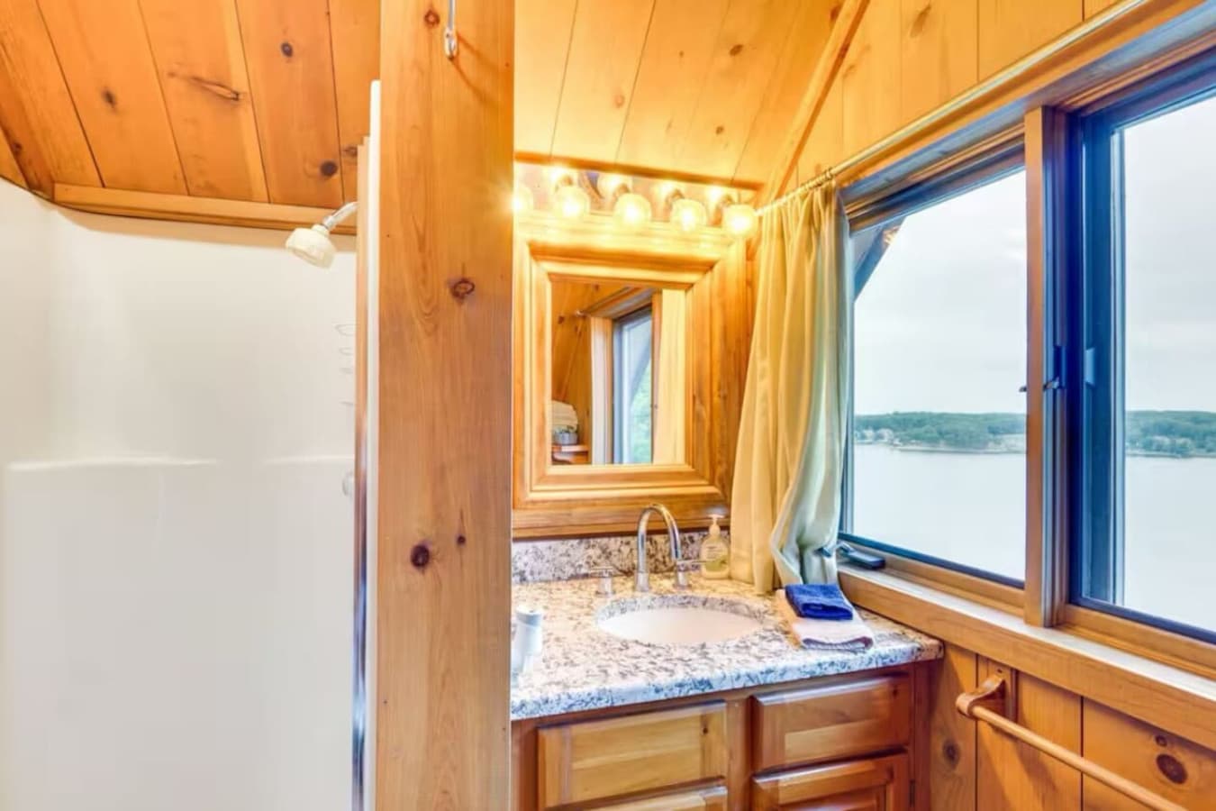 The bunk room includes a private bathroom with a shower, toilet, and vanity for added comfort and convenience.