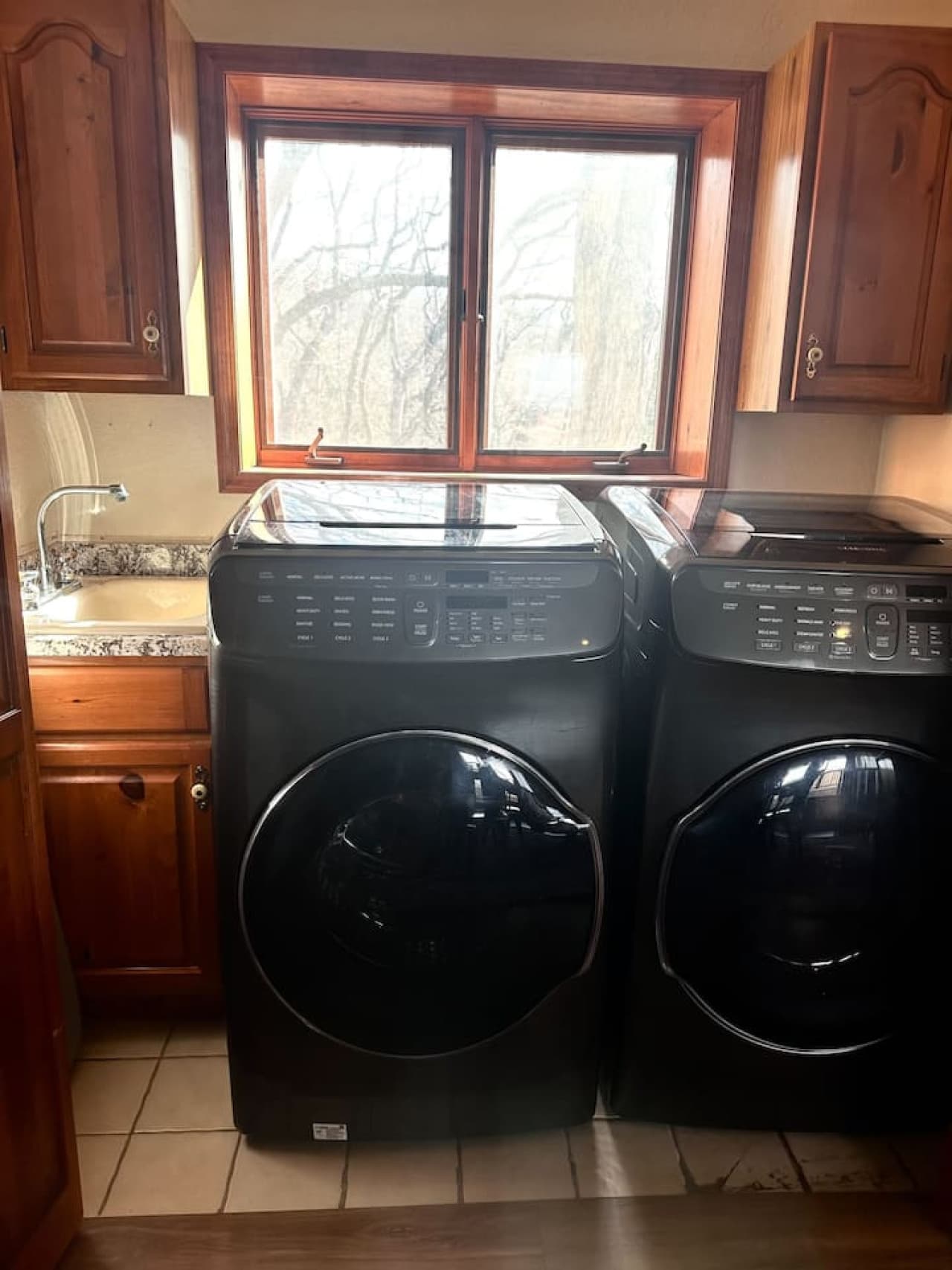 Fully equipped laundry room with modern appliances and a view to make chores a little more enjoyable.
