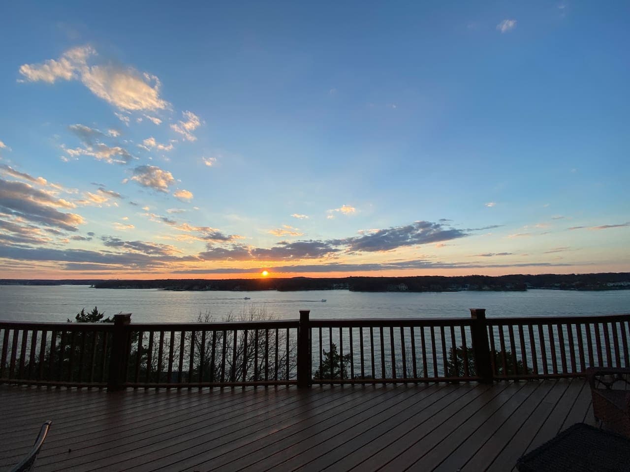 Experience breathtaking sunsets from the expansive deck overlooking the serene lake.