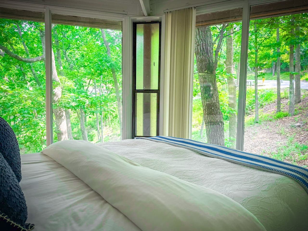 Surrounded by nature, this bedroom is a peaceful retreat where you can truly unwind.