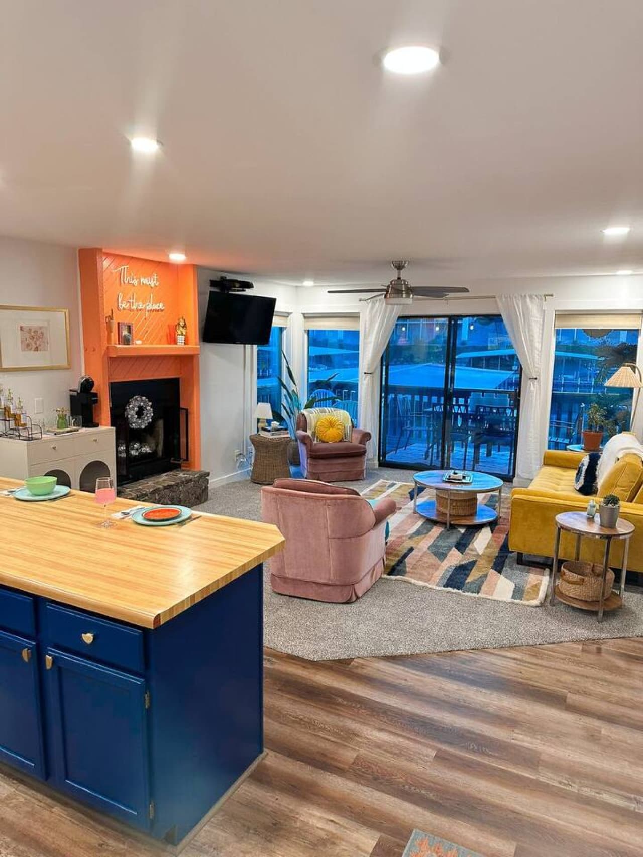 Relax in this colorful, open-concept living space with large windows showcasing stunning lakefront views.