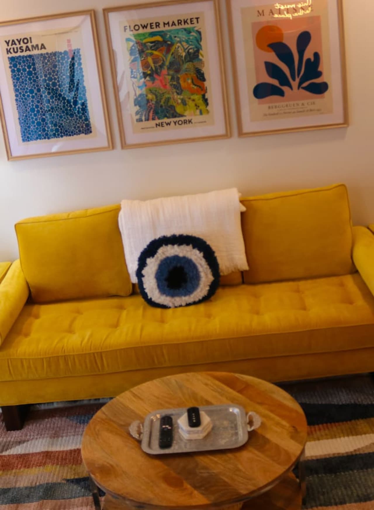 Bright and cozy, the vibrant yellow sofa adds a cheerful touch to this relaxing space.
