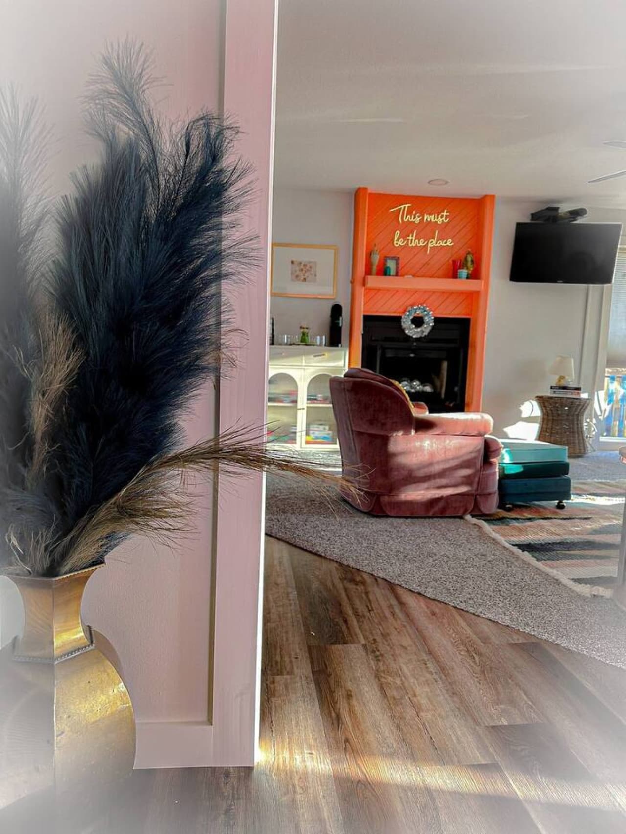 A peek into the living room with natural light, contemporary decor, and comfortable seating.